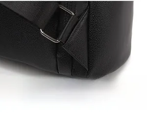 Close-up of reinforced triangle stitching on black lychee leather backpack straps