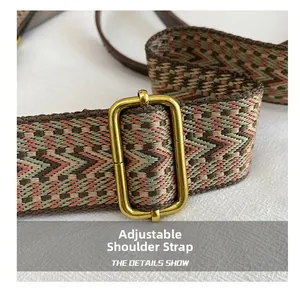 Detail of wide adjustable woven shoulder strap with retro geometric patterns and brass buckle