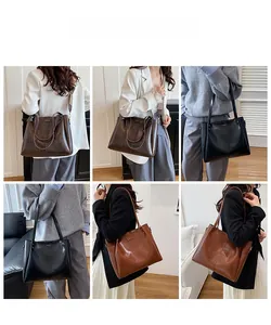 Detail view of large capacity crossbody tote bags in dark brown, black, and tan leather