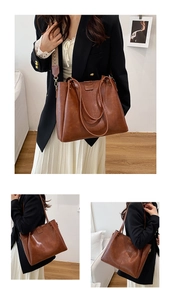 Detail of vintage brown tote bag featuring textured faux leather and floral wide strap