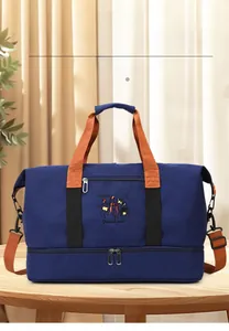 Detail of blue travel bag with separate bottom shoe compartment and orange handles