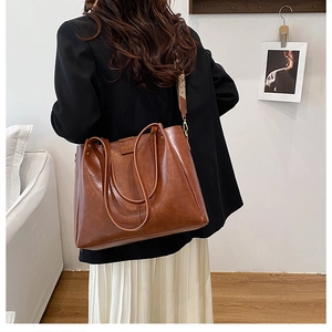 Detail of brown large tote bag featuring vintage patterned detachable wide shoulder strap