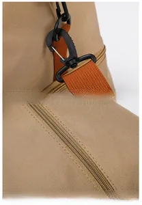 Detail of durable canvas fabric with orange nylon straps and high-quality zipper hardware