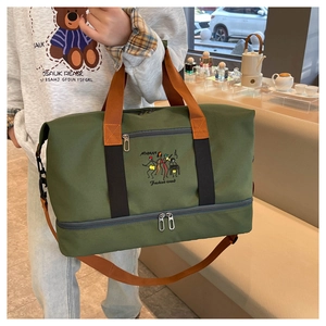 Detail of olive green fitness bag with separate shoe compartment and embroidery