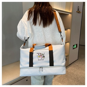 Detailed side view of grey travel bag with orange straps and wet-dry separation