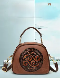 Detailed close-up of retro brown handbag featuring traditional Chinese embossed pattern