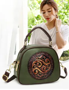 Detail of forest green vintage crossbody bag featuring cloud embossed texture