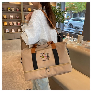 Detail of travel tote showing large capacity and bottom wet/dry separation compartment
