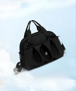 Detail of black nylon tote bag showing pleated design and lightweight texture