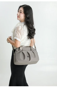 Detail of grey lightweight nylon tote bag with pleated design and detachable shoulder strap