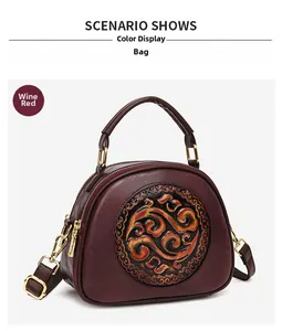 Detail view of wine red shoulder bag featuring elegant Chinese style circular embossing