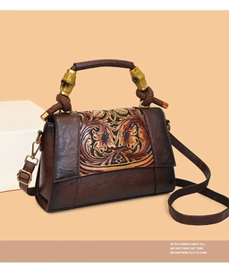 Detailed relief embossing and bamboo handle on this vintage brown leather shoulder bag
