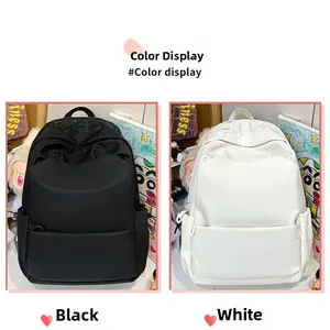 Detail view of solid color large capacity backpacks in black and white with embroidery