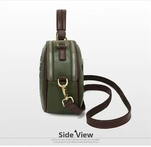 Side view of retro textured leather crossbody bag with dual-zipper design and metal hardware