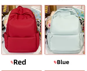 Detail view of large capacity waterproof student backpacks in red and light blue colors