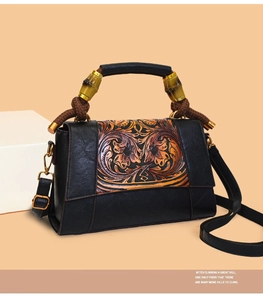 Detailed close-up of retro black leather tote with floral embossing and bamboo handle