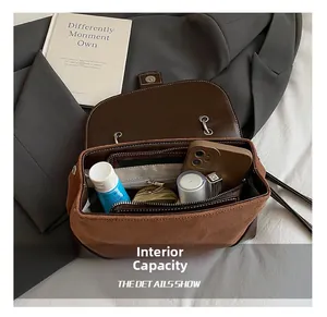 Internal capacity detail of retro brown suede shoulder bag showing spacious compartments