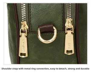 Macro view of olive green pebbled leather bag with gold metal zipper and D-ring hardware