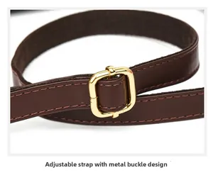 Detail of dark brown leather shoulder strap with adjustable gold square buckle hardware