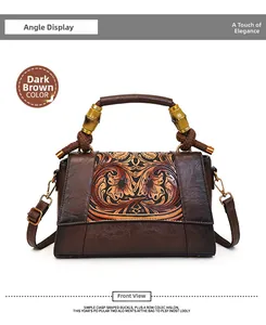 Detail of dark brown vintage handbag with floral embossing and bamboo top handle