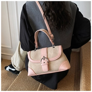 Retro canvas and pink leather patchwork bag shown on shoulder in outdoor setting