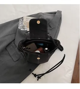 Top view of a black suede bucket bag showing large interior space for daily essentials