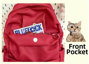 Detail of red backpack front pocket with snap button closure and card storage space