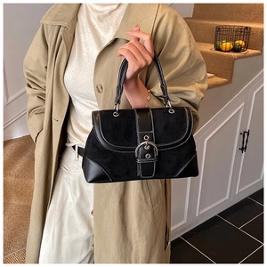 Detail of vintage black bag showing matte and glossy stitching with double white lines
