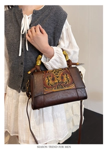 Detailed close-up of retro bohemian handbag featuring hand-carved floral leather pattern