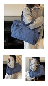 Blue checkered tote bag with side pocket and wide shoulder strap shown in daily usage