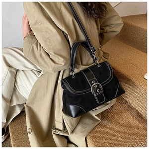 Detailed view of vintage black bucket bag with contrast stitching and silver buckle
