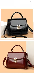 Detail of vintage gold buckle and glossy texture on black and burgundy tote bags