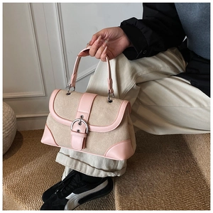 Detail of pink and beige retro patchwork handbag with silver metallic buckle accent