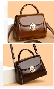 Detail view of stylish caramel and coffee leather handbags with elegant gold metal locks