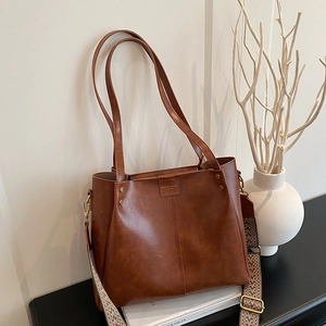 Brown large capacity tote bag with vintage jacquard strap and leather handles