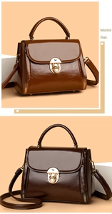 Detailed view of glossy leather handbags with metal twist locks and decorative side zippers
