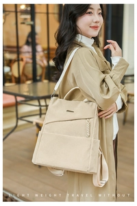 Close-up of beige corduroy backpack texture with metal logo and woven zipper detail