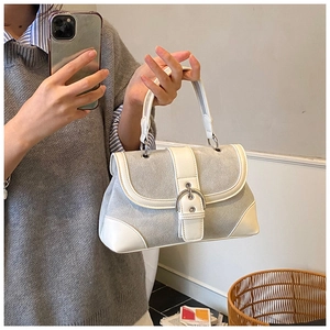 Mirror selfie showing the gray fabric and white leather trim detail of the tote bag