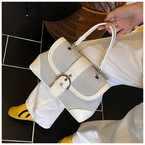 Detail of retro gray fabric handbag with white leather trim and large silver buckle