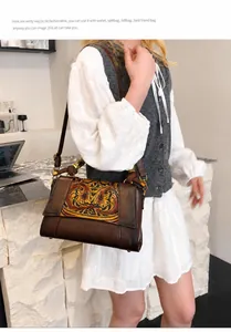 Retro shoulder bag featuring a vintage floral carved pattern and bamboo handle design