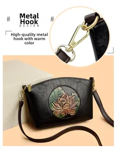Detail of premium golden metal hardware hook and embossed lotus pattern on black bag