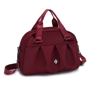 Large burgundy nylon Boston handbag with pleated design and adjustable strap