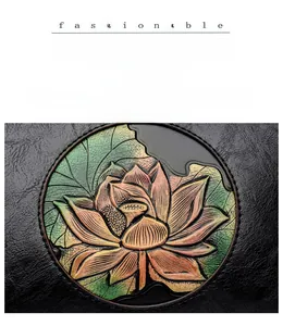 Macro view of embossed lotus flower detail on premium black vintage leather crossbody bag