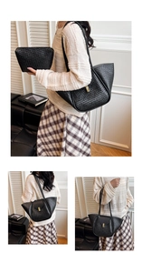 Detail of black woven shoulder bag set with metallic gold buckle and matching cosmetic pouch