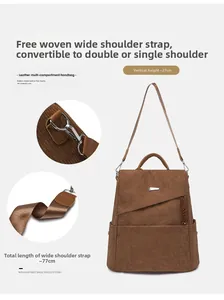Detail of brown corduroy backpack showing dual leather handles and wide woven straps