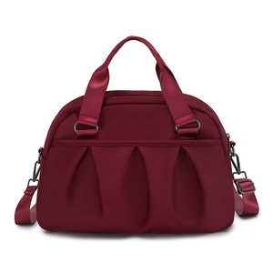 Large dark red nylon handbag with adjustable strap and pleated design for travel
