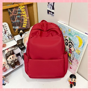 Detail of red backpack top embroidery and durable nylon material for daily travel