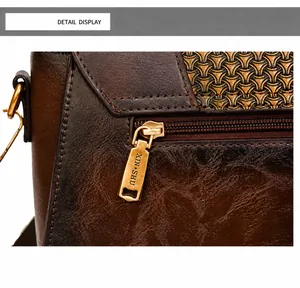 Detail of dark brown leather texture with an embossed finish and a golden metal zipper
