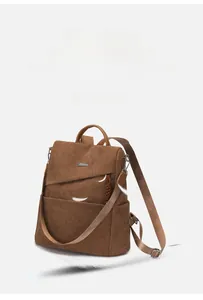 Lightweight brown corduroy backpack detail showing soft material and metal logo finish