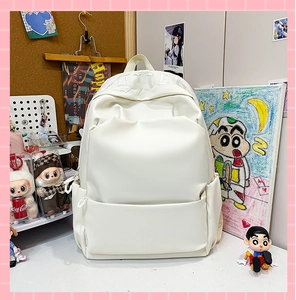 Detailed close-up of white minimalist PU leather backpack with embossed top lettering